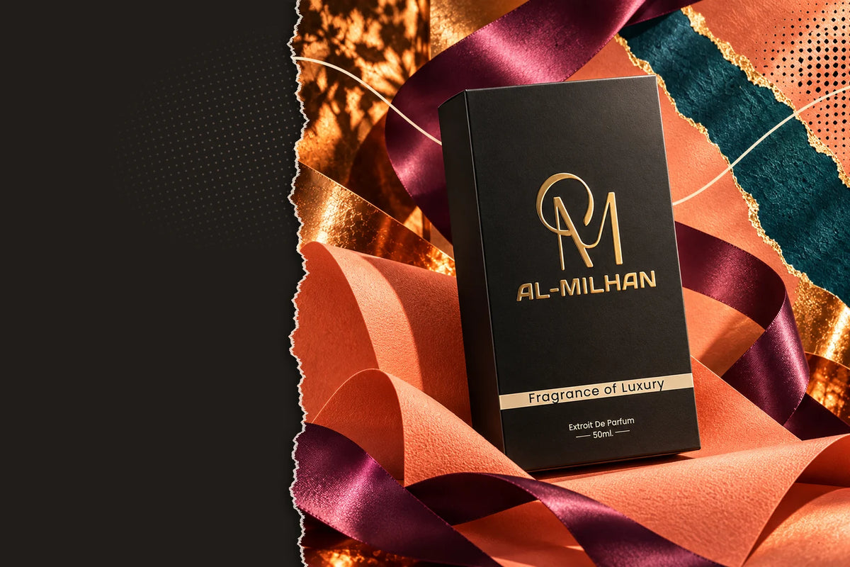 The standard Al Milhan box included with every order: a black carton with the gold AM monogram, AL-MILHAN lettering and a Fragrance of Luxury band, set among coral paper and gold foil.