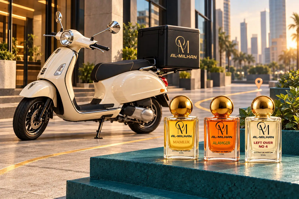 Cream scooter with a black Al Milhan delivery case on a contemporary city street, alongside Mamluk, Alamgir and Left Over No 4 perfume bottles on teal steps.
