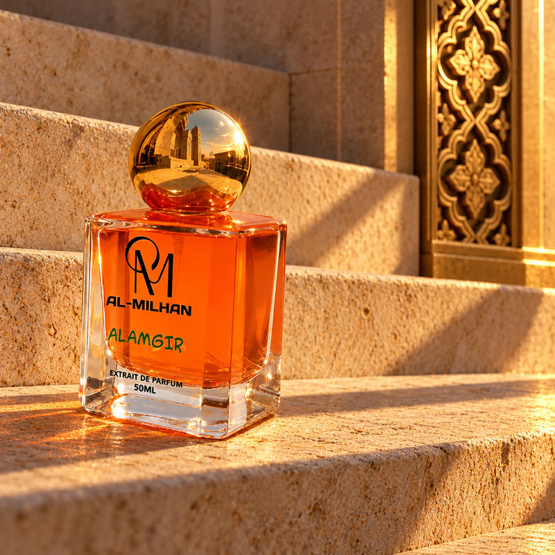 Alamgir perfume with a gold spherical cap and orange fluid on sunlit limestone steps beside carved brass.