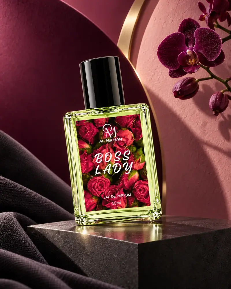Boss Lady bottle with its rosebud label, pale green liquid and black cap on a graphite plinth, framed by plum panels and a purple orchid.