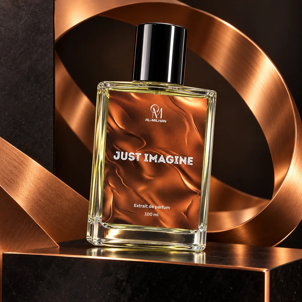 Just Imagine 100 ml perfume bottle with its copper satin label and black cap tilted on a black ledge before a curved copper ribbon sculpture.