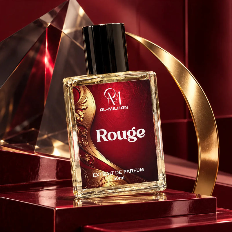 Crystal Rouge 540 perfume bottle by Al Milhan with its burgundy Rouge label on lacquered plinths beside smoked crystal and a brass crescent.
